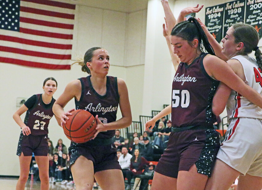 Arlington Eagles Britt Nielsen, from left, Emme Timm &mdash; with the ball &mdash; and Taylor Arp work together to get to the rim Saturday during the NCC Tournament title game in Fort Calhoun.