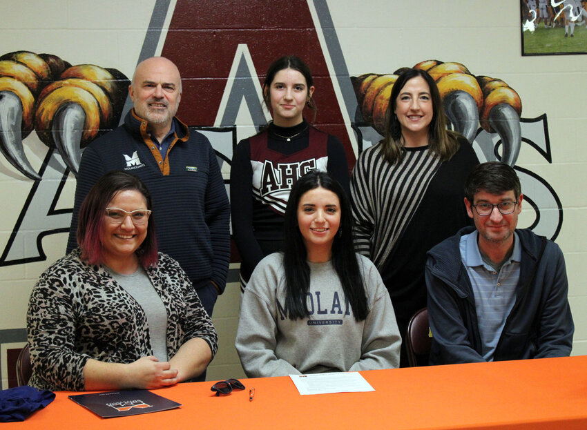 Kayli Praus, a senior at Arlington High School, signed with Midland University for a vocal music scholarship Thursday afternoon in front of family, friends and teachers.