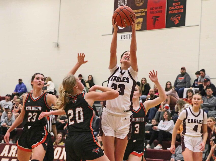 Eagles junior Britt Nielsen, middle, leaps for a high pass into the lane as Fort Calhoun's Bria Bench (23), Maelie Nelson (20) and Raeann Massey (3) watch along with AHS' Macy Wolf on Tuesday at Arlington High School.