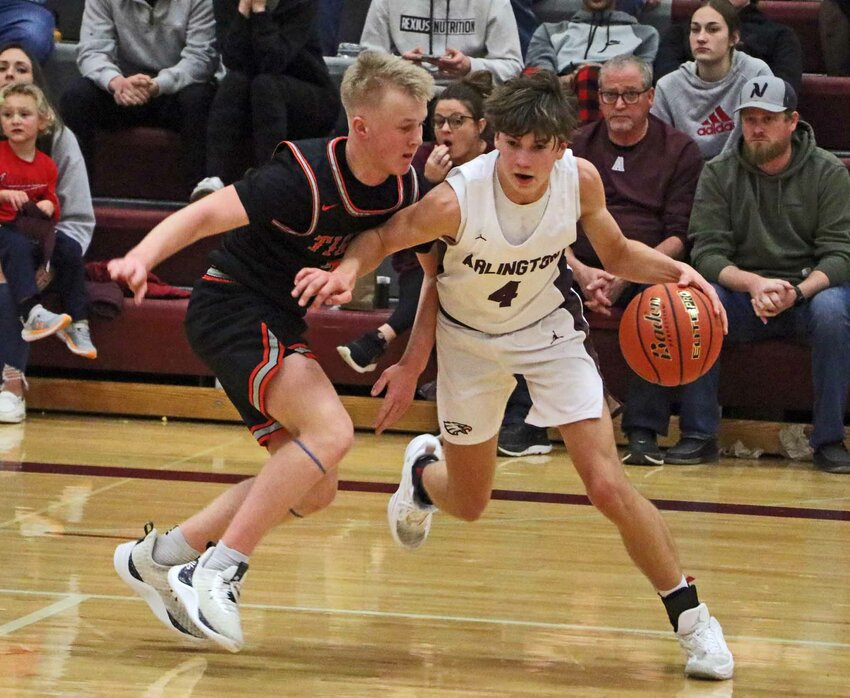 Eagles guard Schuyler Logemann, right, keeps the ball from North Bend Central's Cash Hanis on Monday at Arlington High School.