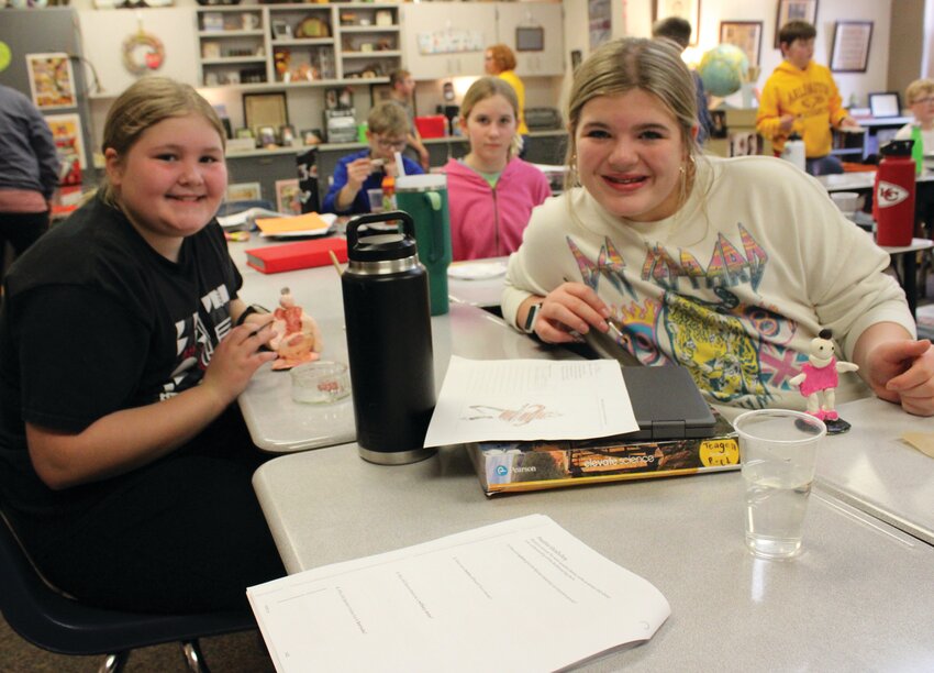 Rylee Strom and Macie Fuscher create their terra cotta soldiers Tuesday in Erin Reed's classroom.