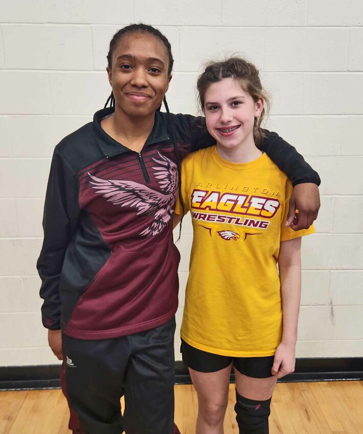 Kelise Krivohlavek, left, and Brooklyn Ruskamp are Arlington High School's first-ever girls to qualify for the NSAA State Wrestling Championships.