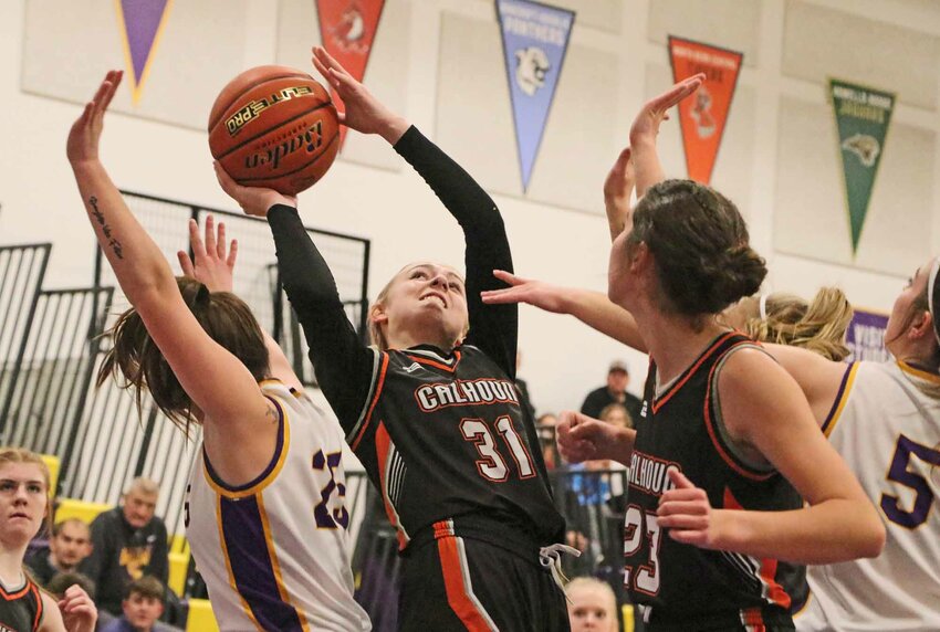 Working alongside teammate Bria Bench, middle right, Fort Calhoun freshman Ansley Elofson, middle right, puts up a close shot intraffic Thursday at Tekamah-Herman.