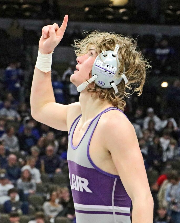 Blair High School senior wrestler Atticus Dick points to the sky after claiming third at 150 pounds Saturday during the NSAA State Wrestling Championships in Omaha.