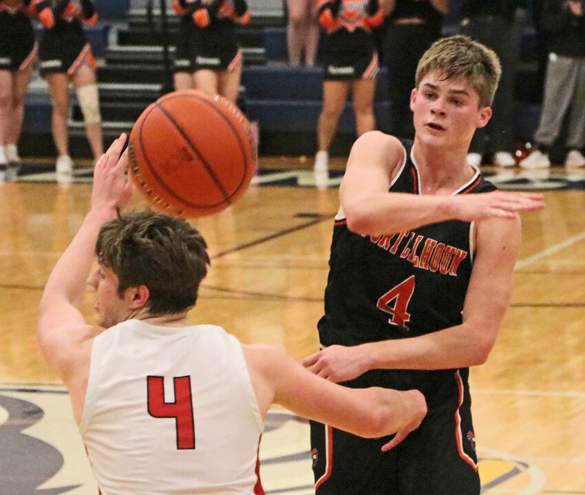 Fort Calhoun senior Grayson Bouwman, right, passes the ball over the head of Douglas County West's Karsten Alexander on Tuesday during the Class C1-4 Subdistrict Tournament at Omaha Concordia.
