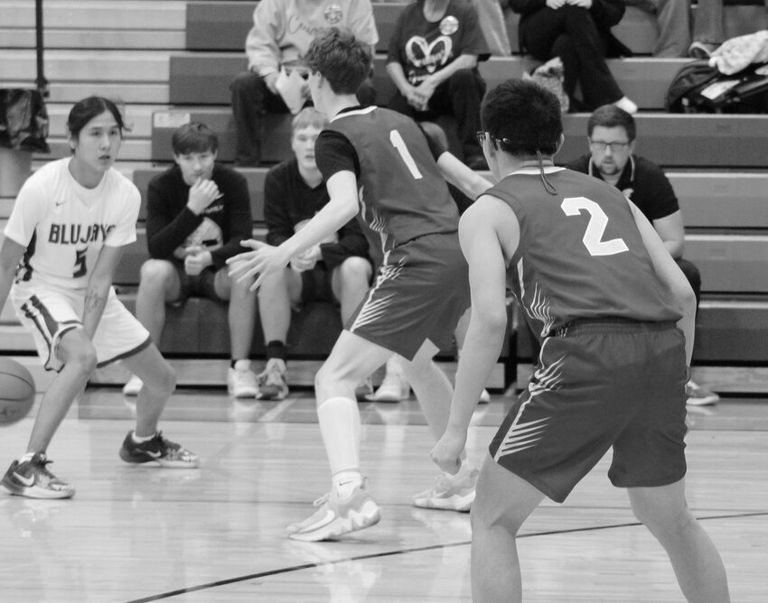 (1)Brady Hayes and (2) Braden Hardin had their eyes on their opponent as they tried to defend the hoop.