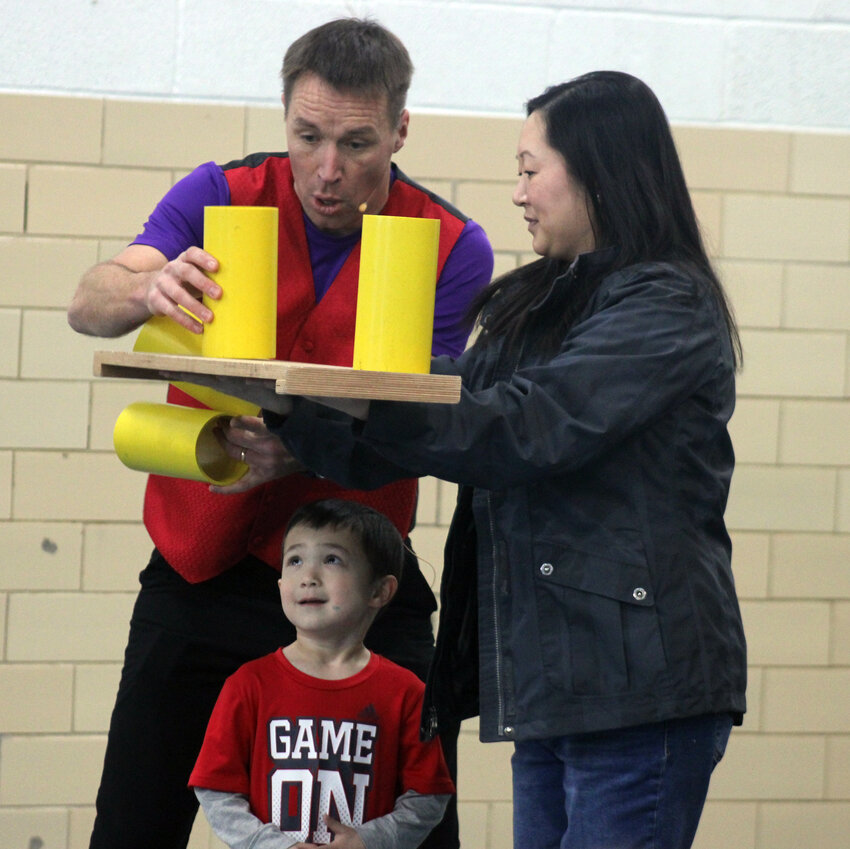 Luke Winger has volunteers Kaisha and Parker Hilgenkamp help him out with his next juggling trick Wednesday afternoon at St. Paul's Lutheran School.