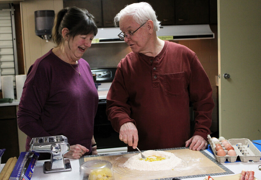 Janice and Dale Ordway create pasta Thursday at the Community Building for an event held by the Arlington Public Library.