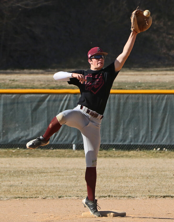 Infielder Tanner Kyllo reaches for a high throw to second base Tuesday during Arlington High School baseball practice at the Washington County Fairgrounds. The Eagles start the season today in Ralston.