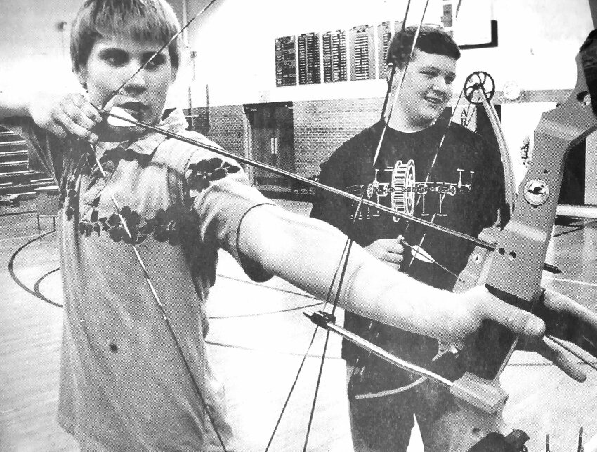 Nick Mohan, left, and David Poe practice archery during a 2005 physical education class at Arlington High School.