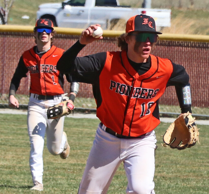 Fort Calhoun infielder Chase Bierman, right, starts a rundown between first and second base as AJ Duros lends support Saturday at Omaha Roncalli. The Pioneers started their season against the Pride and Twin River on Saturday after Thursday's home opener was postponed by the wet weather.