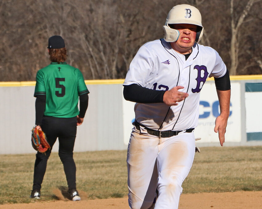 Blair senior Dylan Swanson, right, races to third base on his way home for a run Monday at Vets Field. The varsity Bears played their home opener with Omaha Skutt, but the junior varsity game was called off due to low temperatures.
