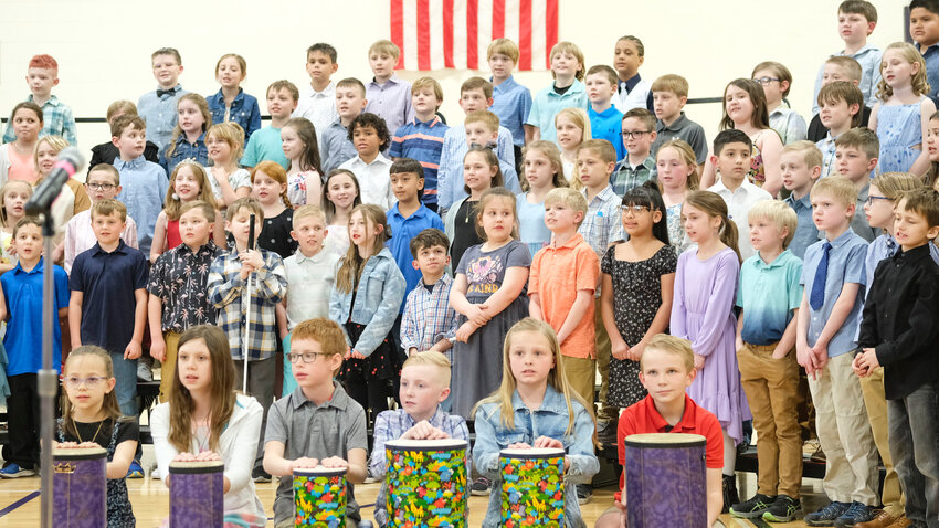 Students in the front row play drums while the combined second and third grade classes sing &quot;Sarasponda&quot; Tuesday during the Arbor Park Spring Sing, held at Otte Blair Middle School.