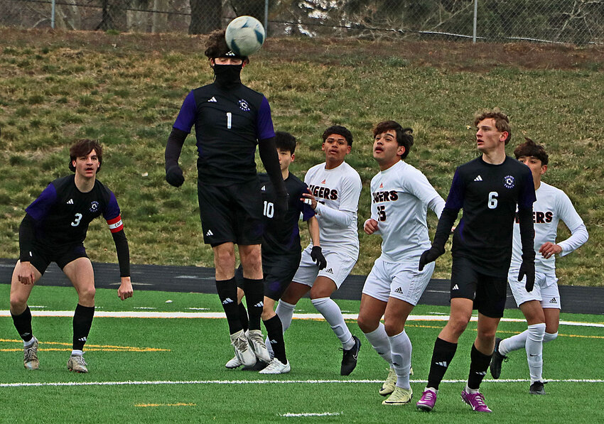 Blair senior Ethan Lundgren (1) heads the ball with teammates Colton Matney (3), Sakuto Yamada (10) and Alex Just (6) lending support Saturday against Hastings at Krantz Field.