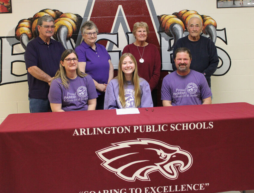 Brooke Hilgenkamp, center, signed her letter of acceptance into Kansas State University's Early Admission Program for Veterinary School in front of family and friends Tuesday afternoon at Arlington High School.