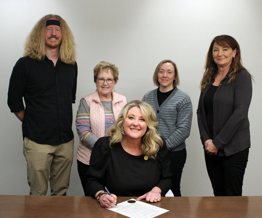 Blair Mayor Mindy Rump signs a declaration for National Library Week for the Blair Public Library March 25. Pictured with Rump, from left, Carson Norine, Joleene Rewerts, Brooke Zarco and Mary Berg.