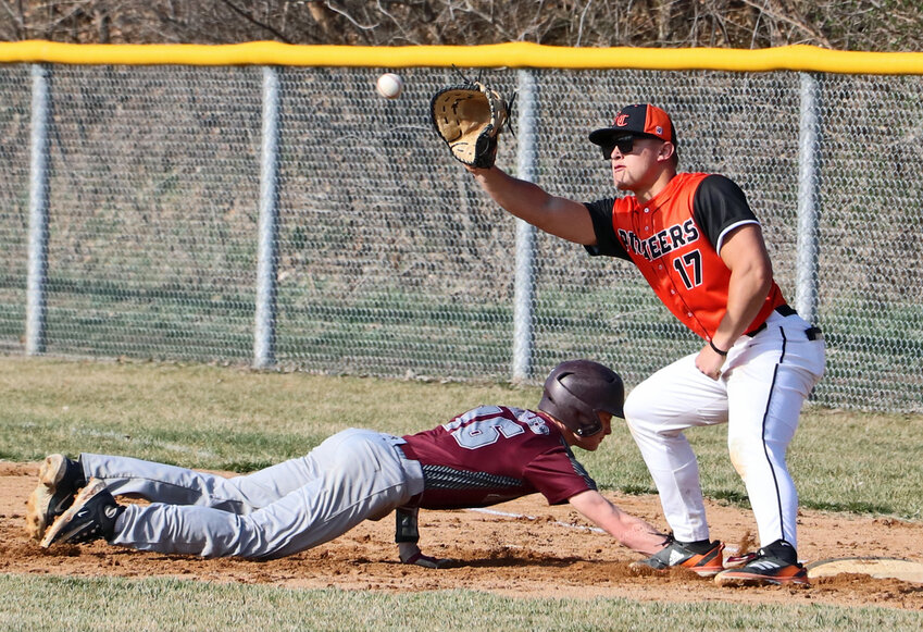 The Eagles' Luke Sharp, left, dives back to the bag as Fort Calhoun's Alex Christensen nabs the pick-off attempt Thursday at the Washington County Fairgrounds.