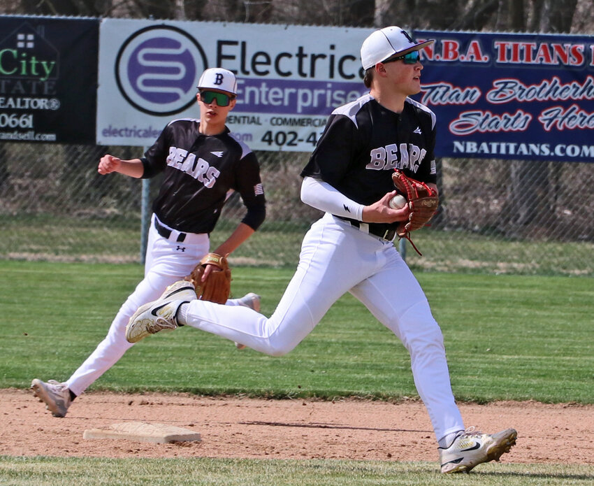 Blair shortstop Tanner Jacobson, right, transfers the ball from his glove to his throwing arm Friday as Owen Mann backs him up at Hickman City Park. The Bears beat Class B No. 6 Norris for their first win of the season, 6-4.