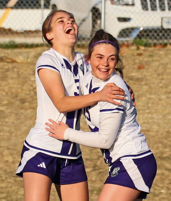 Blair Bears Kaitlynn O'Neil, left, and Emmi Hall celebrate a goal March 27 at Omaha Concordia. The Bears beat the Mustangs, 9-2.