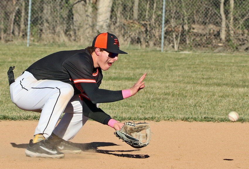 Pioneers shortstop Kenny Wellwood fields a grounder Thursday against Wahoo/Neumann in Fort Calhoun. The Warriors routed FCHS, 17-1.