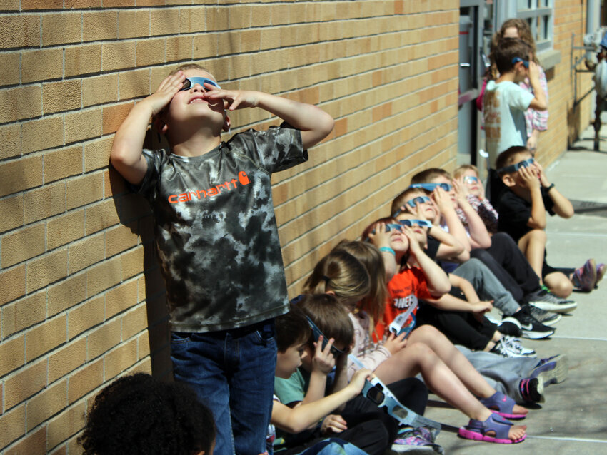 Kindergarteners in Mallorie Neubaum's class view the solar eclipse Monday afternoon