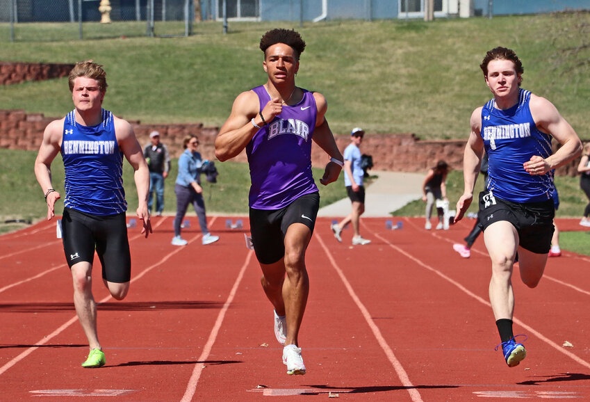 Blair senior Ethan Baessler, middle, races down the track Tuesday at Plattsmouth High School. The sprinter won this 100-meter dash heat and the finals race.