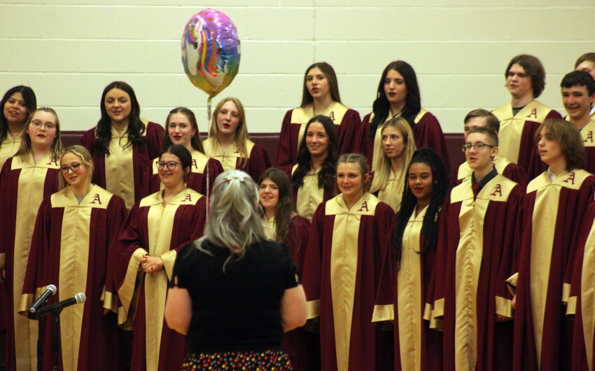 The Arlington High School Choir sings &quot;Happy Birthday&quot; to band director Allison Mastny Tuesday evening during the spring music concert.