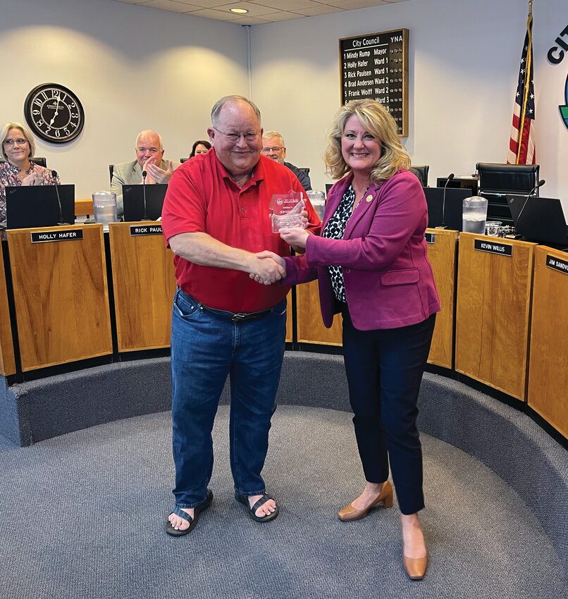 Blair Mayor Mindy Rump presents a plaque to Don Hansen at Tuesday&rsquo;s City Council meeting in recognition of his 40 years of service on the Blair Planning Commission.
