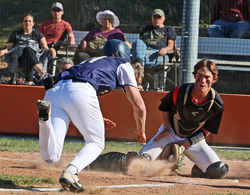 Pioneers catcher Chase Bierman, right, gloves a bouncing throw to home plate Friday in Fort Calhoun. Bierman tagged the Raymond Central runner out on the play.