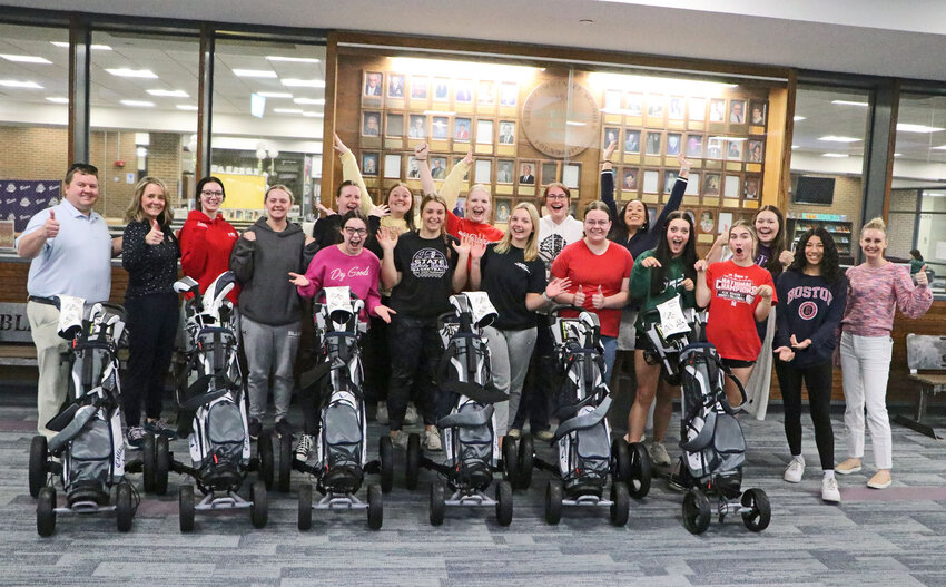 The Blair High School girls golf team poses for a celebratory photo with its new clubs and carts presented to them by the PGA REACH Nebraska Foundation on April 10. Coach Rachel Brown's squad received the equipment through the Club FORE Youth Program.