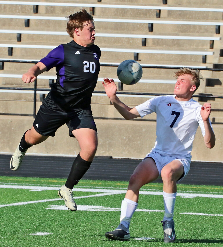 Blair senior Riley Wolff, left, knocks the ball down with his chest as Norris' Hayden Nielson moves in Monday at Krantz Field. The 2-9 Titans beat the Bears 4-3 in an overtime shootout.