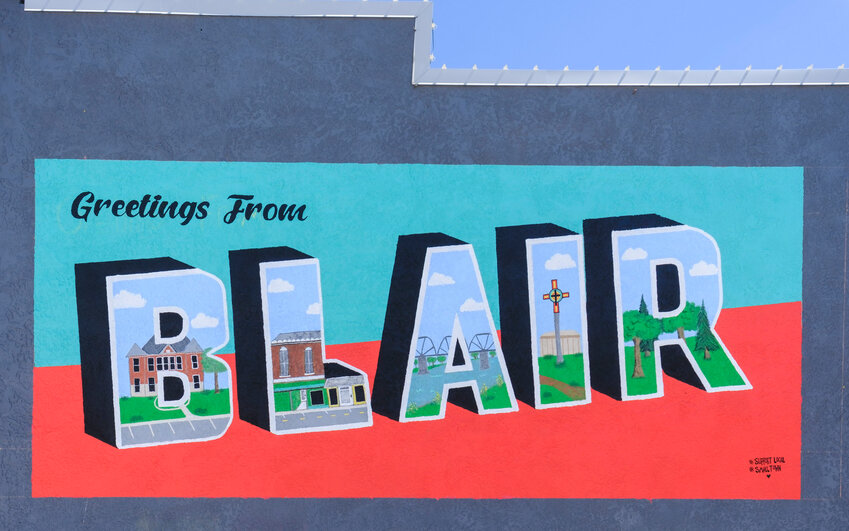 A new &quot;Greetings from Blair&quot; mural is now officially completed. The mural is located on Main Street on the side wall of Joseph's Coat/Washington County Food Pantry.