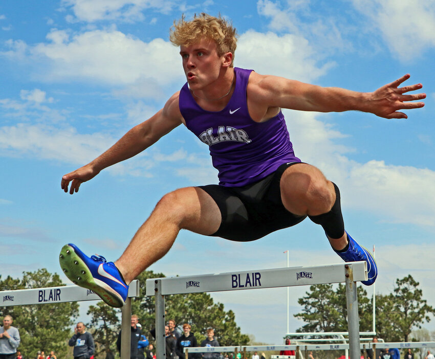 Bears senior Ben Holcomb clears a 110-meter high hurdle Thursday during the Mike Lehl Invite at Blair High School's Krantz Field. Coach Bryan Soukup's boys team won the meet with a first-place finish in the final race.