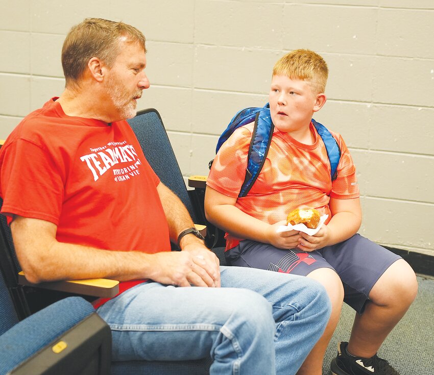 Logan View Mentor Kris Kremke and mentee Bryon Vollmer enjoy the back to school breakfast at the start of the school year hosted by TeamMates with donations from the Fremont Area Big Give.