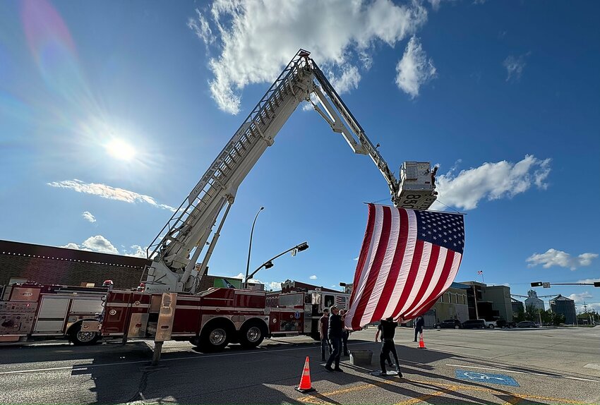 The Blair Volunteer Fire and Rescue Department displays a large flag on 16th and Washington streets during Cruise Night Saturday.