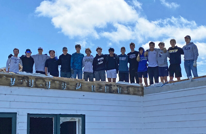 Members of the Blair High School boys soccer team pose for a photo atop a Washington County home damanged during the April 26th tornado. The Bears spent April 27 helping in recovery efforts instead of playing a previously scheduled subdistrict game, which was postponed.