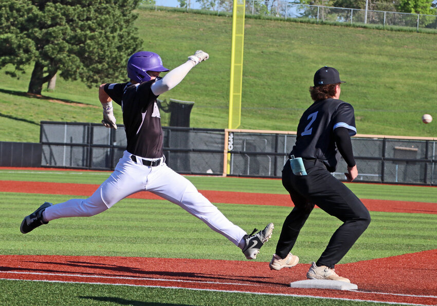 Blair senior Tanner Jacobson, left, reaches for the bag Saturday at Tal Anderson Field, beating a throw to Elkhorn North's Bodie Sellmeyer for an infield single. The Wolves beat the Bears during the NSAA Class B State Championships first round game in Omaha, 7-3.