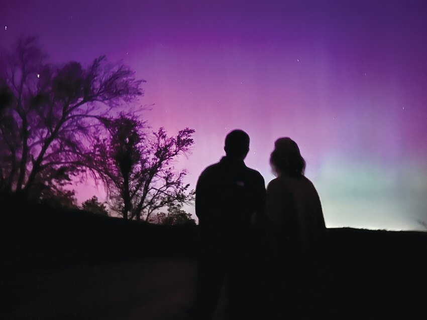 Dane and Lisa Johnson of Oakland enjoy the Aurora Borealis on early Saturday morning.  The phenomena, rare in this part of the world dazzled locals not once but twice as the sky was lit again early Sunday morning.