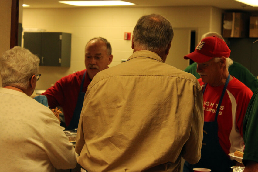 The Nebraska Knights of Columbus group prepared a free dinner of pulled meat sandwiches and other items for victims of the April 26 tornado at St. Francis Borgia Catholic Church Sunday evening. The group also donated $100 gift cards to victims to buy whatever they need amid their loss.