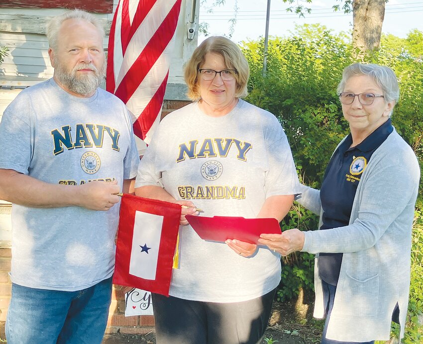 Paul and Cindy Norton were presented a Blue Star Banner to display as their  grandson Amon Bryan serves in the United State Navy.  Deb Hawkins, right, and Sansha Landholm, not pictured, made the presentation.