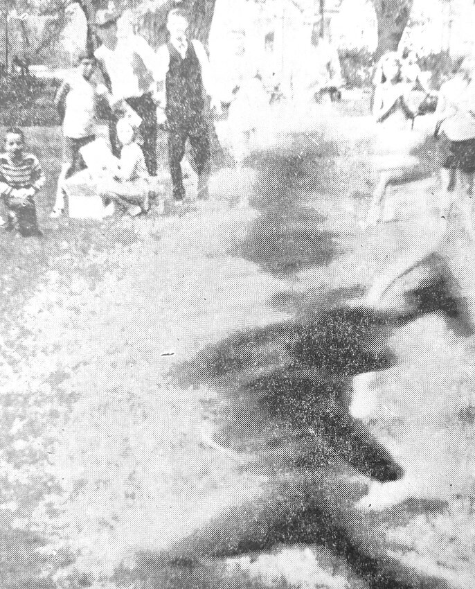 The camera couldn't catch this runner in 1967 during the Arlington Centennial Celebration, but it did catch Bob French, Jerry Fagerquist and others in the background, who are watching the finish line.