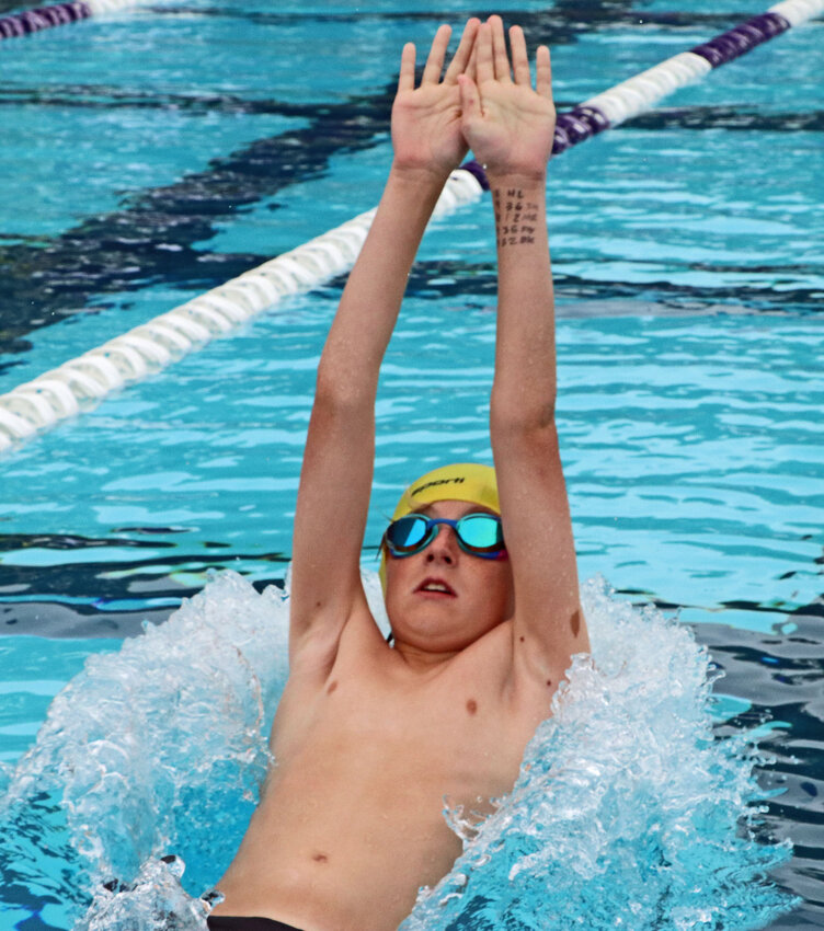 Cooper Norine of Blair starts his backstroke lap Saturday at the Blair Municipal Pool. Norine's team hosted the confernce championship meet as Arlington and other attended.