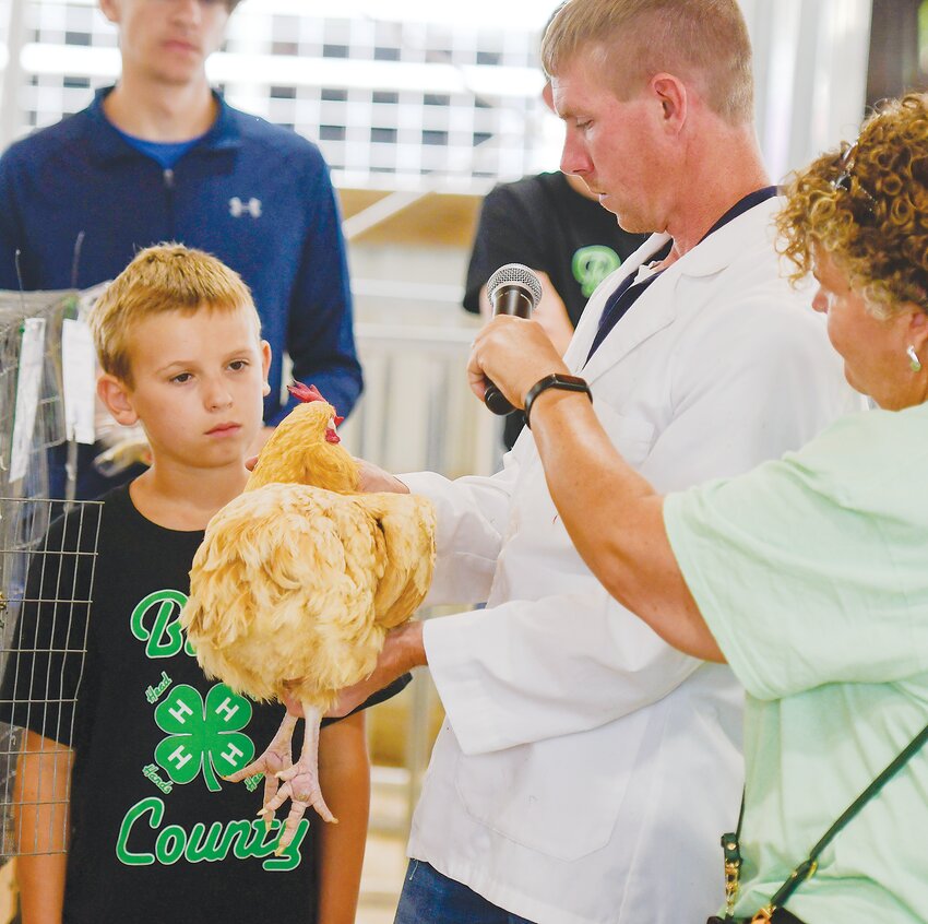 Zane Rief gets listens to comments from judge Brett Kreifels of Springfield during the poultry shows.