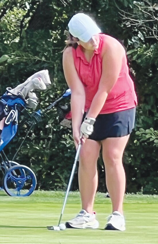 Freshman Josie Peterson lines up a putt in Blair.