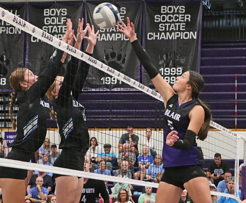 The Bears' Ally Sullivan, right, attempts to clear the net and an Elkhorn North block Tuesday at Blair High School.