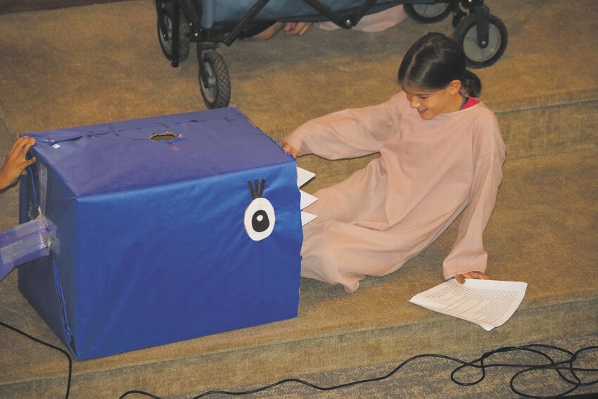 Naomi Duley is reenacting a scene from &quot;Jonah and the whale&quot; during a recent chapel service at St. Paul's Lutheran Church &amp; School.