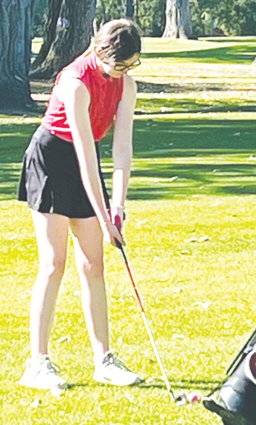 Junior Piper Tanksley prepares a fairway shot in Stanton.