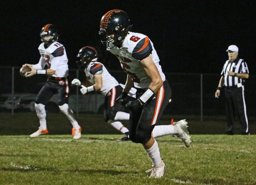 Fort Calhoun's Chase Premer runs upfield at the snap as Adam Elofson, far left, carries out a handoff fake with Levi Lasher on Friday at Omaha Concordia. The Pioneers beat the Mustangs 41-17, improving to 6-1.