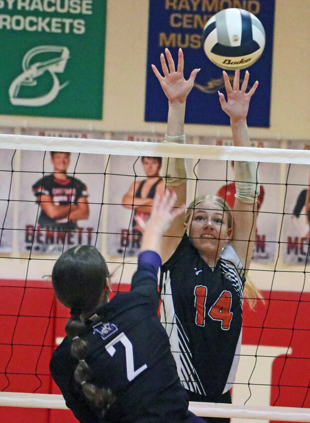 Fort Calhoun's Ali Dill, facing, attempts to block the attack of Louisville's Whitney Haynes on Thursday at Yutan High School.