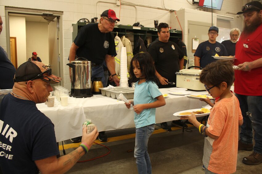 Joe Leonard, Blair fire chief, gets his niece and nephews drinks with for their breakfast.